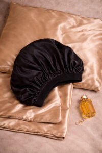 Satin bonnet and pillowcase flat lay for Black hair care