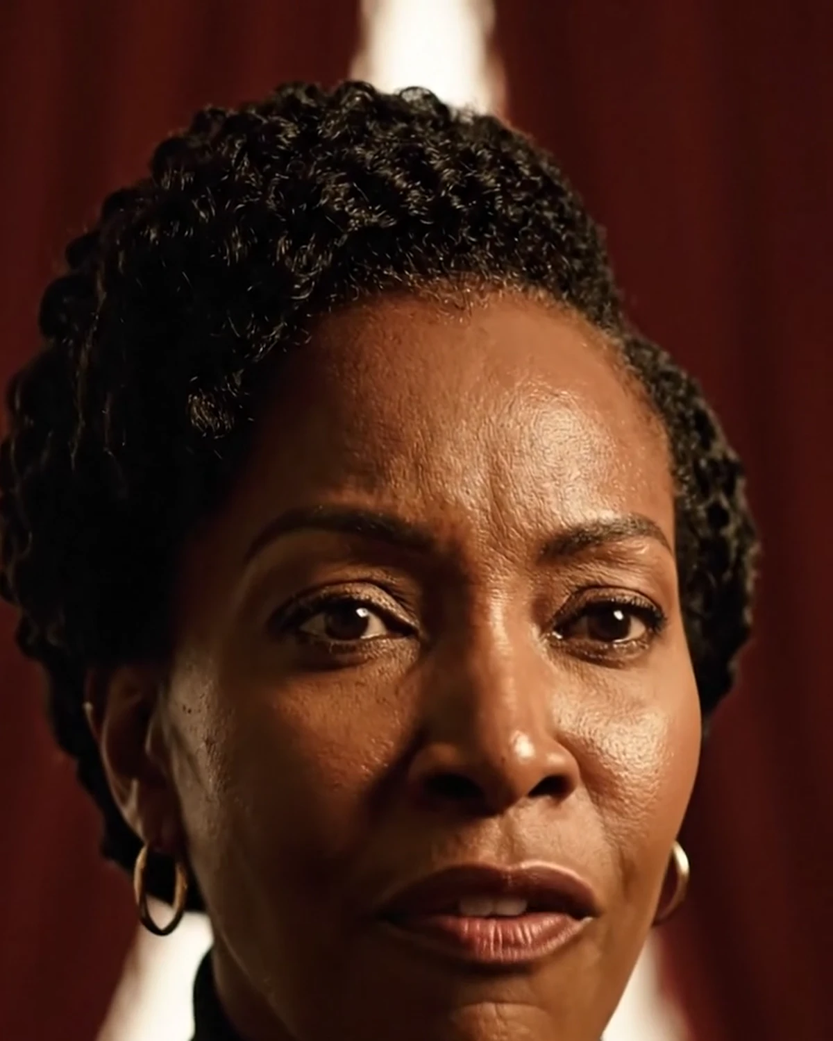 Black woman in a dramatic burgundy editorial portrait representing the intensity of a toxic relationship