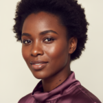 Black woman with rich brown skin in an editorial portrait for dark spots after tweezing facial hair on black women