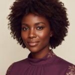 Black woman with rich brown skin in an editorial portrait for how to know when your routine is finally working