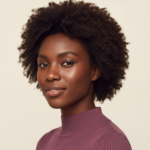 Black woman with rich brown skin in an editorial portrait for what to keep and what to pause during a skin reset